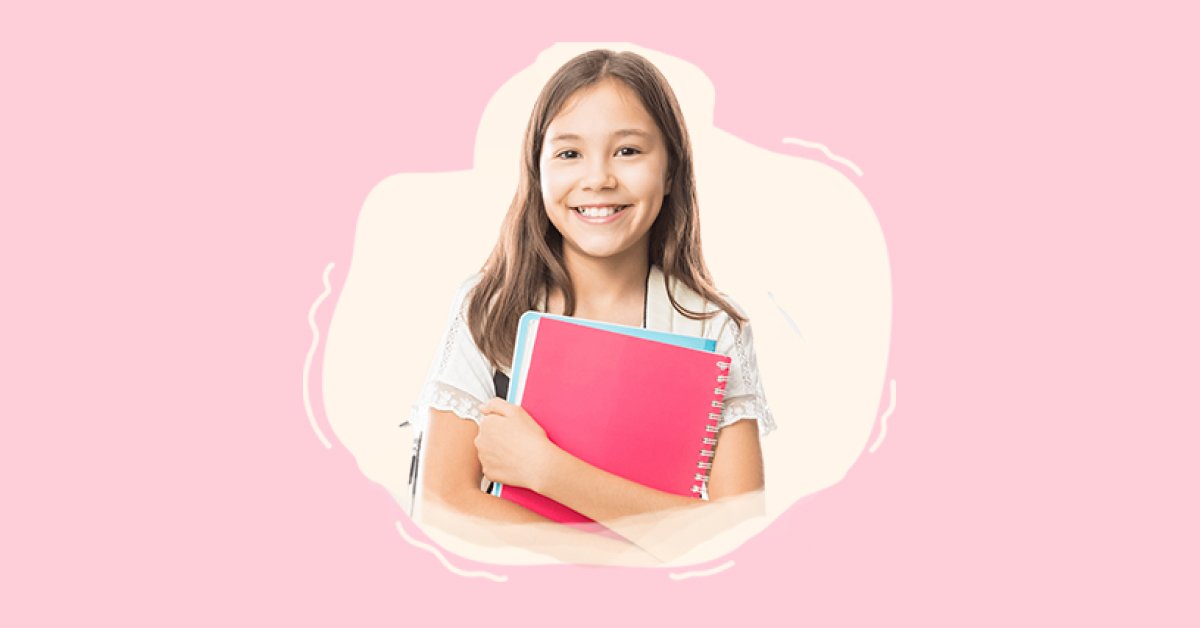 Girl student holding books and smiling