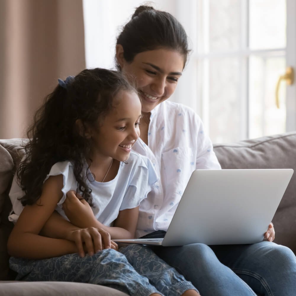 Mother and daughter learning together in online reading program