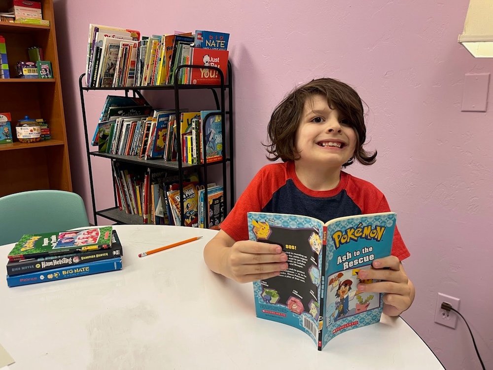 Second grader reading Pokemon Book