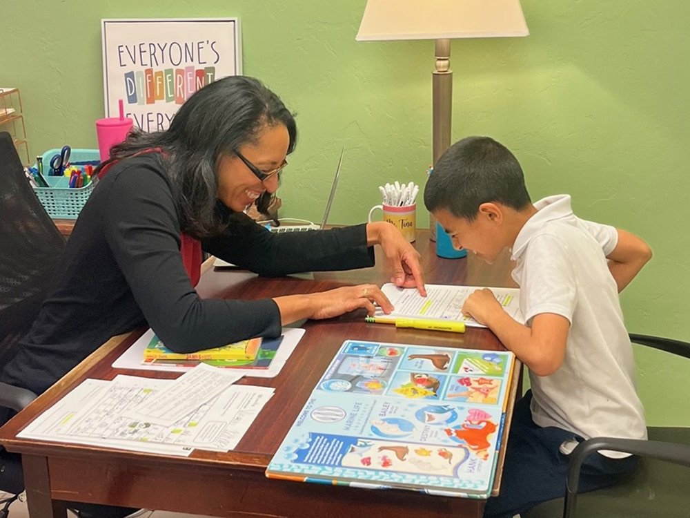 Tina tutoring with autism student