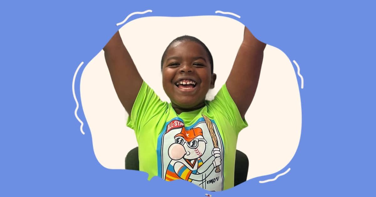 Happy student with arms raised