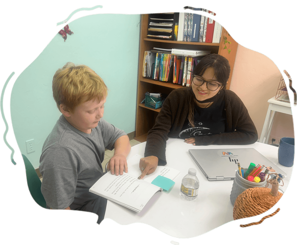Tutor with Dyslexia student pointing at book